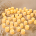  numerous lit candles on a textured surface with dried flowers